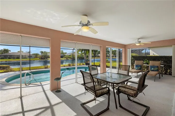 Large covered outdoor living space to relax and entertain by the pool.