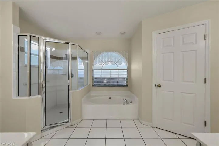 Bathroom with dual vanities and separate shower and tub
