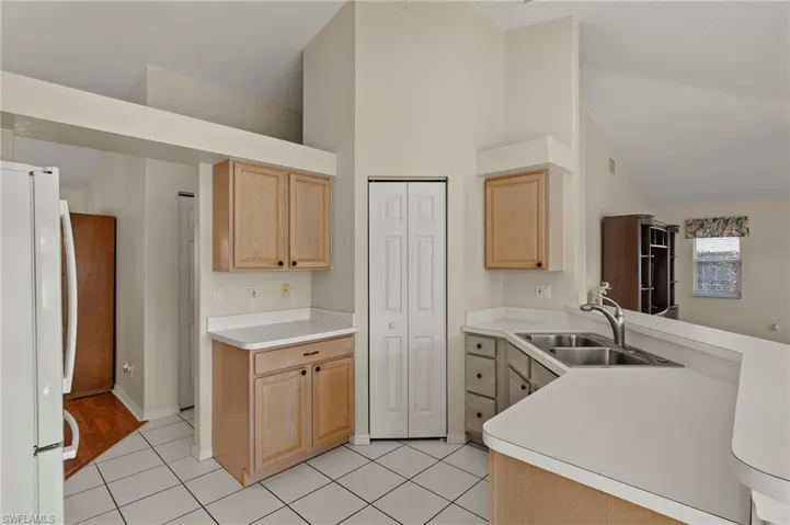 Kitchen featuring a pantry, built-in cabinetry and additional kitchen & hall storage closets.