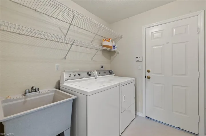 Laundry room, washer & dryer, sink, door to garage.