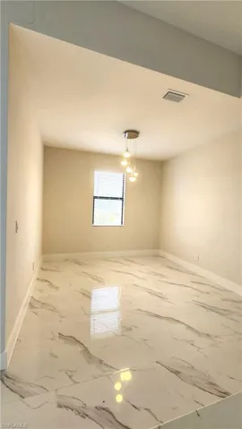 Dining room featuring baseboards and marble finish floors