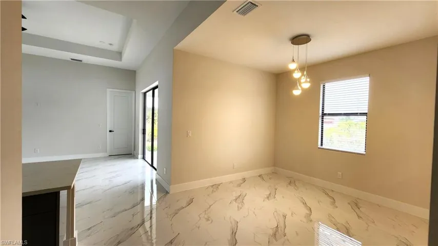 Dine area featuring light marble finish flooring and plenty of natural light