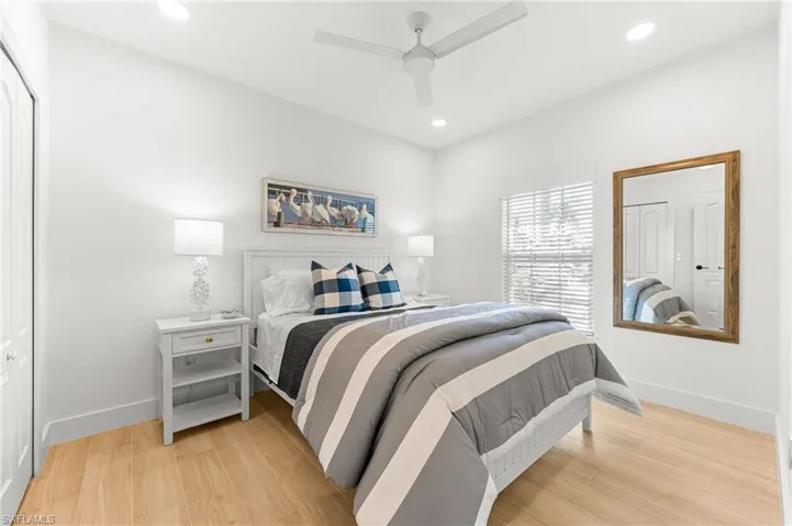 Bedroom featuring light wood finished floors, recessed lighting, ceiling fan, and a closet