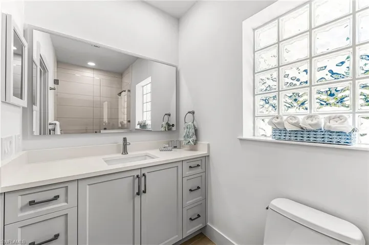 Full bath with vanity and a tile shower