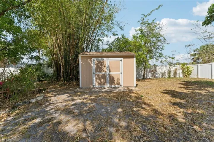 View of shed featuring fence