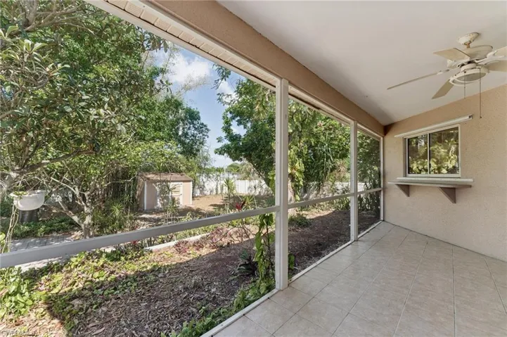 Unfurnished sunroom featuring ceiling fan