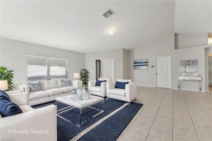 Virtually Staged Living area featuring vaulted ceiling, visible vents, baseboards, and light tile patterned floors