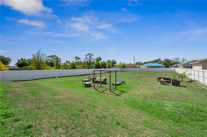 Fenced backyard with a fire pit