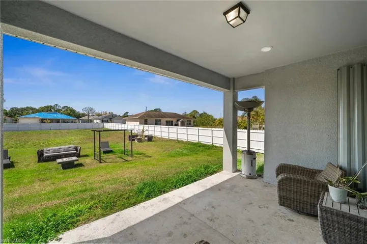 Fenced backyard featuring a Lanai