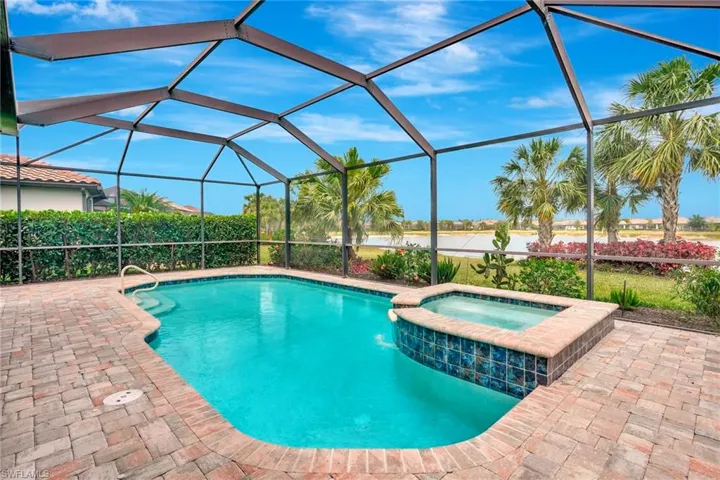 View of swimming pool featuring a patio, a lanai, and a pool with connected hot tub