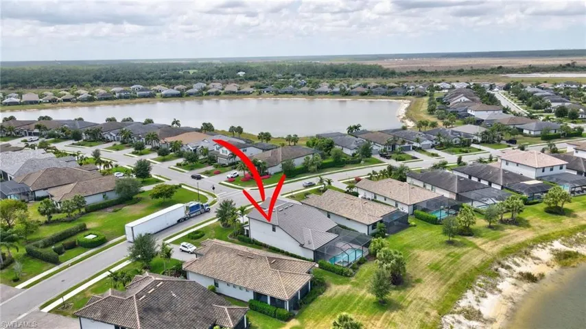 Drone / aerial view with a water view and a residential view
