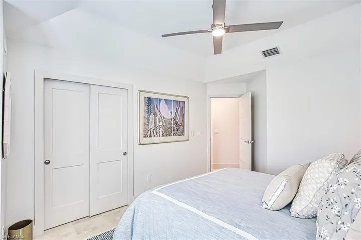 Bedroom featuring a ceiling fan, a closet, and tile patterned flooring