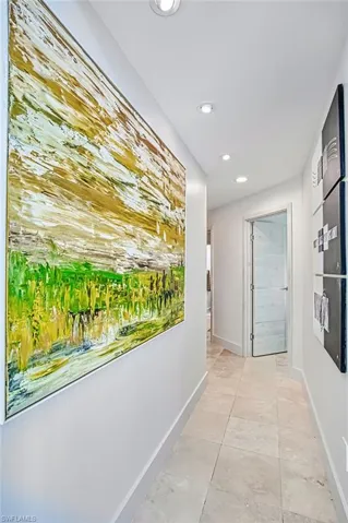 Corridor featuring recessed lighting and light tile patterned floors