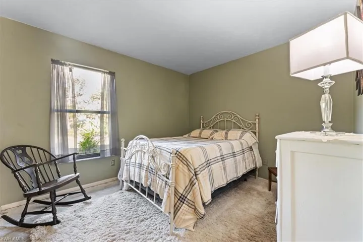 Bedroom with baseboards and carpet floors