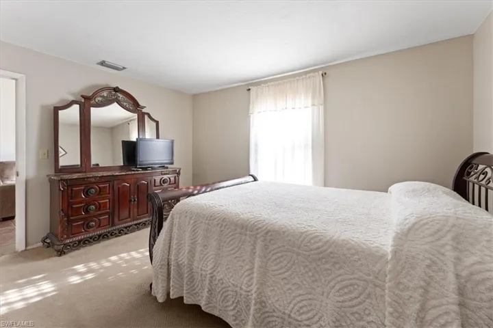 Carpeted bedroom with visible vents
