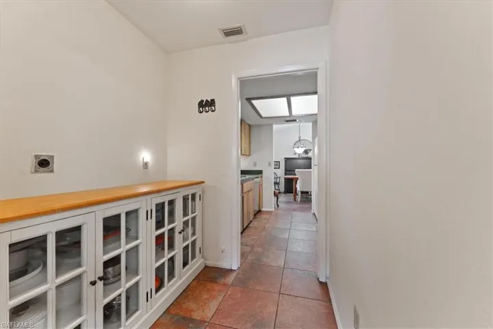 Hall featuring visible vents and baseboards
