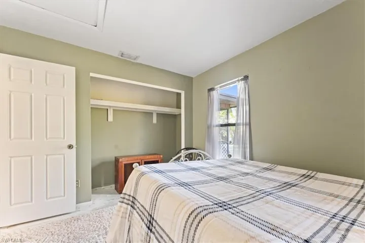 Bedroom featuring a closet and visible vents