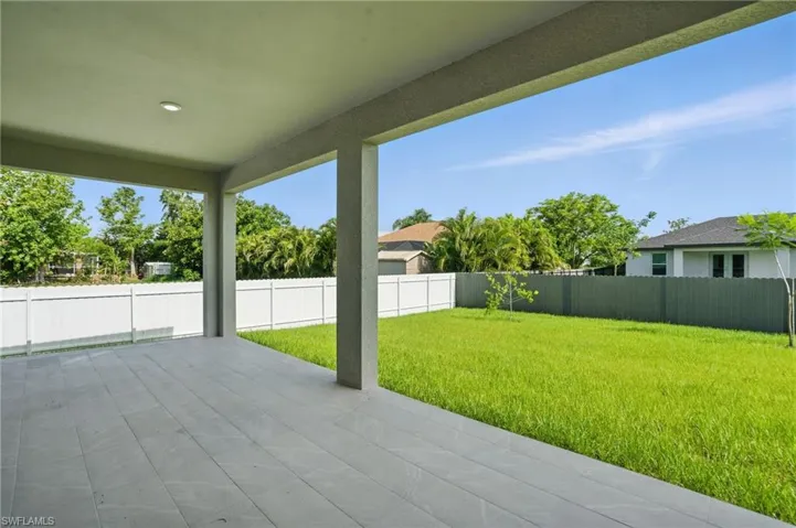 Fenced backyard with a patio area
