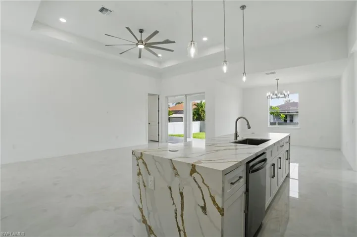 Kitchen featuring dishwasher, plenty of natural light, a ceiling fan, recessed lighting, and a chandelier