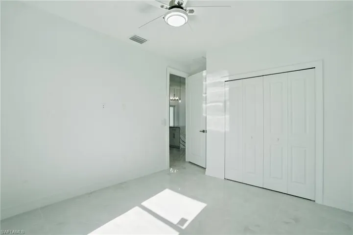 Unfurnished bedroom featuring ceiling fan and a closet