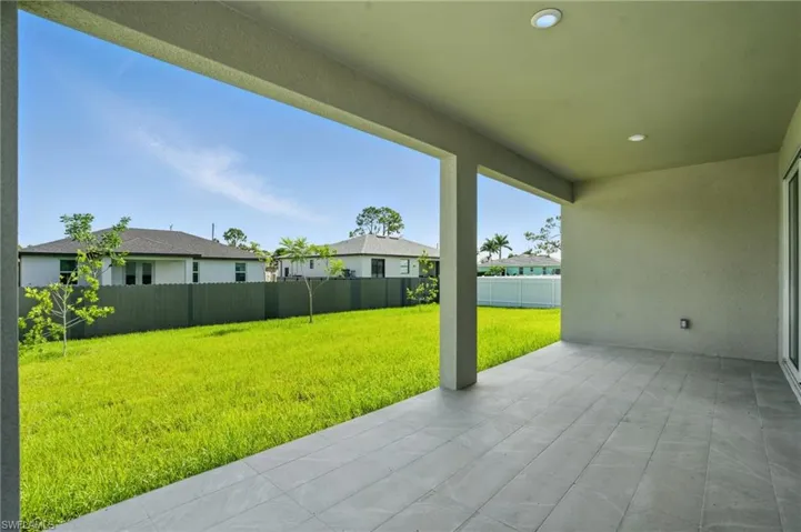 Fenced backyard featuring a patio and a residential view