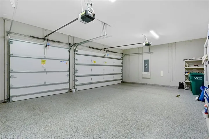 Garage with electric panel and a garage door opener