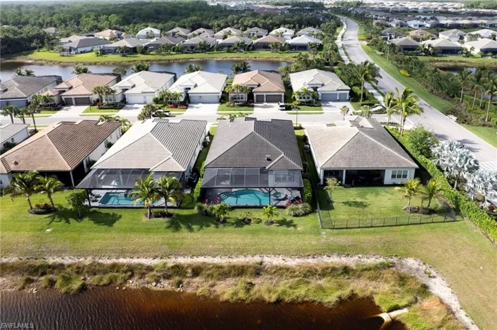 Drone / aerial view with a residential view and a water view