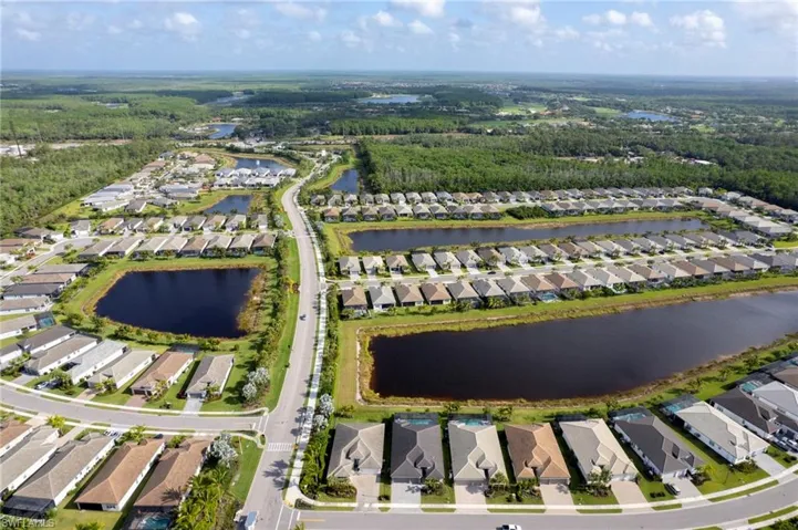 Drone / aerial view with a residential view and a water view