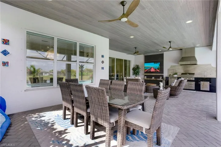 View of patio featuring outdoor dining area, a ceiling fan, and area for grilling