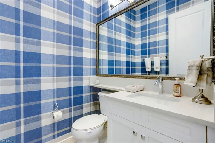 Half bath featuring toilet and vanity