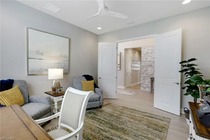Office space featuring recessed lighting, baseboards, light wood-style floors, visible vents, and ceiling fan