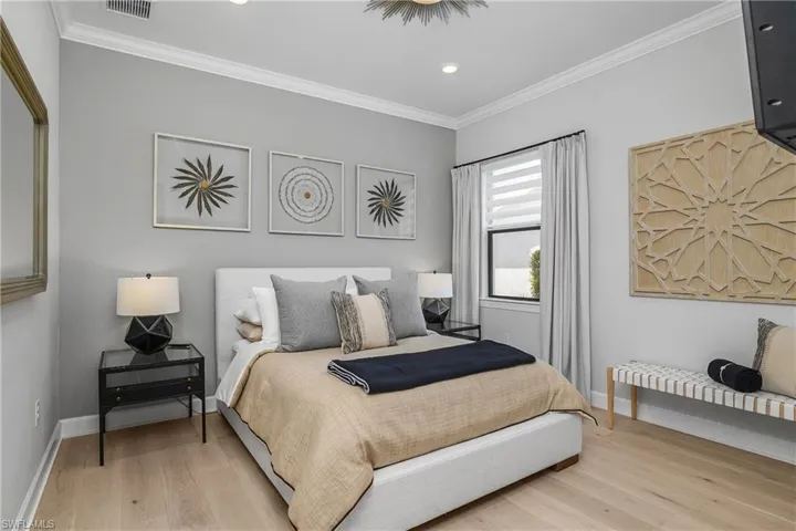 Guest Bedroom features crown molding, designer lighting and recently installed hardwood flooring.