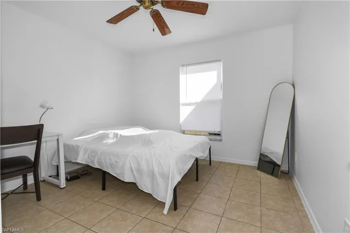Bedroom featuring a ceiling fan and light tile patterned floors