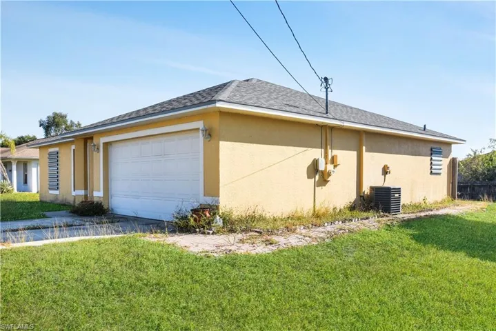 View of property exterior featuring a lawn, stucco siding, roof with shingles, and an attached garage