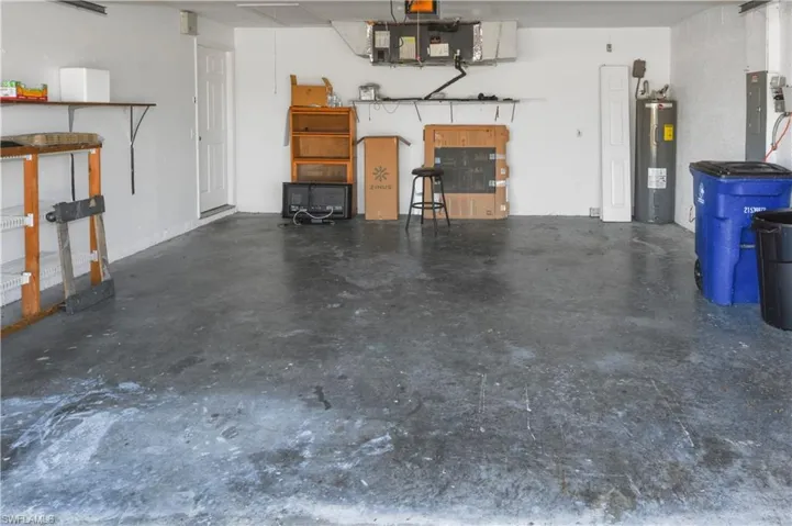 Garage with water heater and electric panel