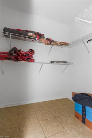 Spacious closet featuring light tile patterned flooring