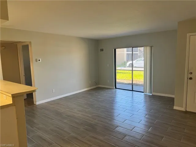 Unfurnished living room with dark hardwood / wood-style flooring