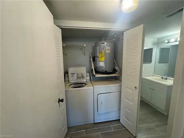Laundry room with separate washer and dryer, and electric water heater