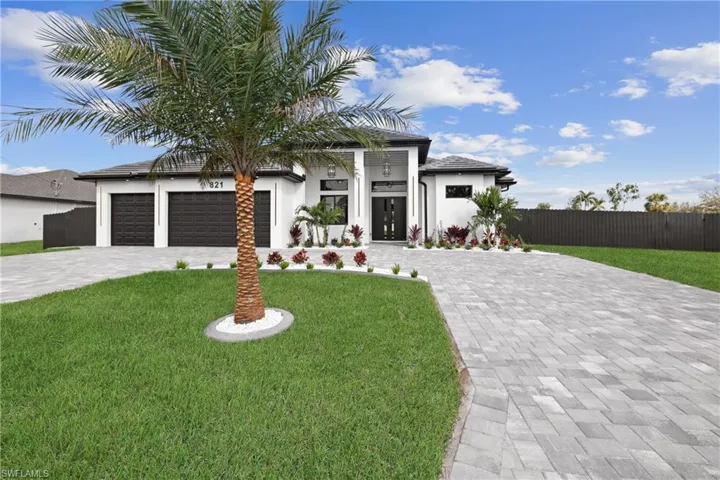 View of front of home featuring a garage and a front yard