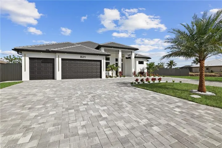 Prairie-style home with a garage and a front yard