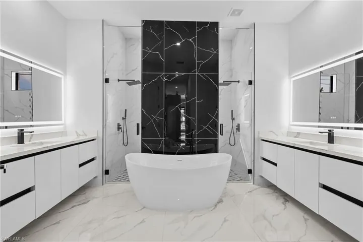 Bathroom featuring vanity and shower with separate bathtub