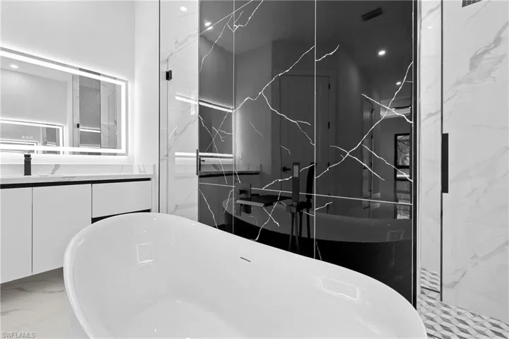 Bathroom featuring vanity and plus walk in shower