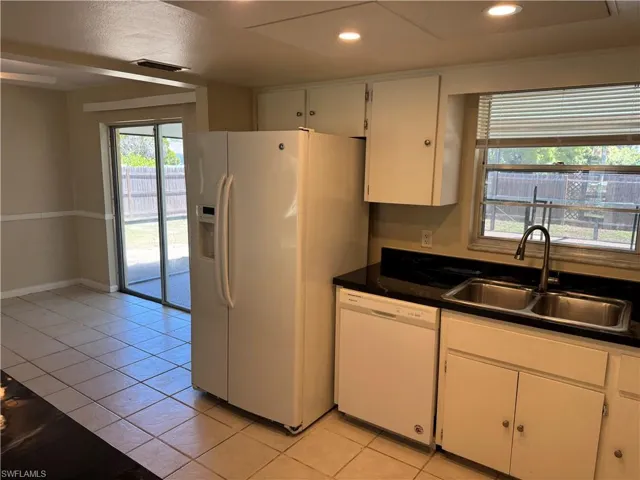 Standing near pantry closet looking through kitchen towards patio door