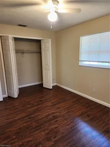 Front Guest Bedroom Closet with ceiling fan and light