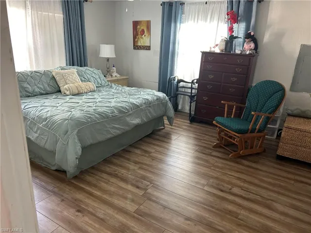 Bedroom featuring hardwood / wood-style flooring and electric panel