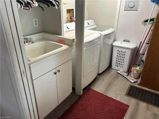 Laundry area featuring light wood-type flooring and independent washer and dryer
