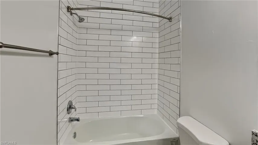 Full bath featuring shower / washtub combination and toilet