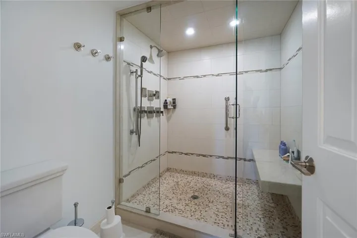 Full bathroom with a stall shower and recessed lighting