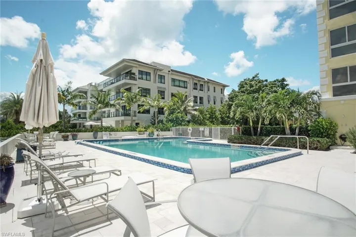 Community pool with a patio