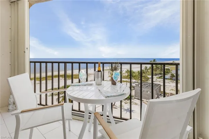 Balcony with view of water and beach